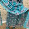 A Turquoise Floral-Print Salwar Kameez With White Lace Detailing On The Neckline, Matching Trousers, A Coordinating Dupatta
