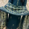 A Deep Teal Kurti Set With Subtle Embroidery, Paired With Printed Pants And A Matching Floral Dupatta Draped Elegantly