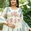 A Graceful Ivory Kurti Set Featuring Soft Pastel Floral Prints, Paired With Matching Pants And A Delicate Blue Dupatta.