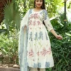A Graceful Ivory Kurti Set Featuring Soft Pastel Floral Prints, Paired With Matching Pants And A Delicate Blue Dupatta.