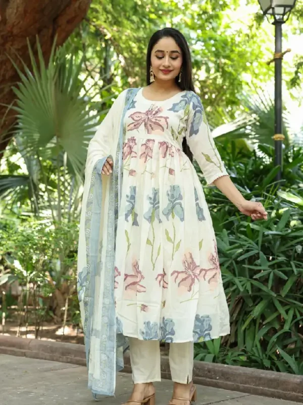 A Graceful Ivory Kurti Set Featuring Soft Pastel Floral Prints, Paired With Matching Pants And A Delicate Blue Dupatta.